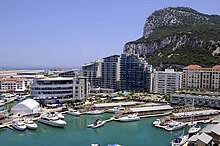 Ocean Village Marina in Gibraltar, a luxury marina resort with premier berths for yachts. Ocean Village berths with rock behind.jpg
