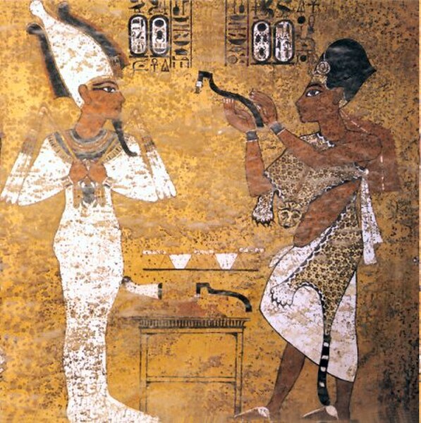 Ay, with a leopard skin, performing the opening of the mouth ceremony for Tutankhamun, scene from Tutankhamun's tomb.