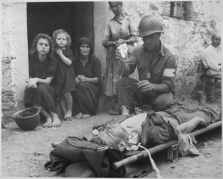 File:Private Roy Humphrey of Toledo, Ohio, is being given blood plasma by Private First Class Harvey White of Minneapolis... - NARA - 531161.tif