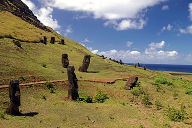 Outer slopes of Rano Raraku with twenty moai, some buried to the neck Rano Raraku quarry.jpg