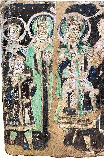 Tocharian royal family (King, Queen and young blond-hair Prince in Tocharian clothing), Kizil, Cave 17 (entrance wall, lower left panel). Hermitage Museum.[162][163][164][165]