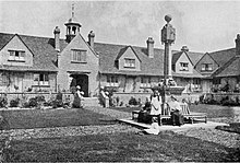 Photograph of the quadrangle at Sidney Hill Cottage Homes looking towards the central archway and sundial.