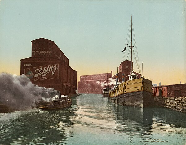 A 1900 advertisement for Schlitz beer, located along the South Branch of the Chicago River at 14th Street. Underneath the logo it states, "the beer th