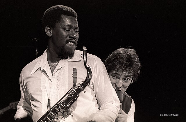 The cover art of Born to Run features Springsteen (right) leaning on the shoulder of E Street Band saxophonist Clarence Clemons (left).