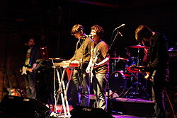 Концерт The Main Drag в 2007 году. Фото Криса Айрлэнд. Слева направо: Джон Картер, Дэн Кардинал, Адам Арриго, Мэтт Бох. Не на фото: Джон Дрейк.