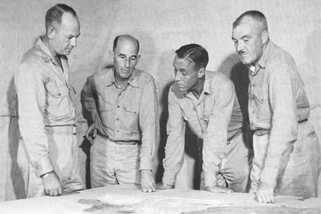 Lemuel C. Shepherd (left) speaks with members of his staff during a planning meeting prior to the Guam operation. Next to him is 1st Brigade Chief of 