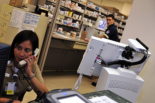 US Navy 100623-N-7364R-084 Hospital Corpsman 2nd Class Donna May Rigby answers a phone call as Hospital Corpsman 3rd Class John McCallum prepares a prescription by using a telepharmacing system at the Naval Support Activity (NS