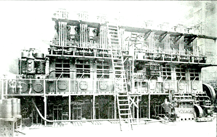 One of the eight-cylinder 3200 I.H.P. Harland and Wolff – Burmeister & Wain diesel engines installed in the motorship Glenapp. This was the highest powered diesel engine yet (1920) installed in a ship. Note man standing lower right for size comparison.