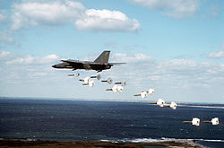 A 509th Bombardment Wing FB-111A aircraft drops Mark 82 high drag practice bombs along a coastline during a training exercise DF-ST-91-02468.jpg