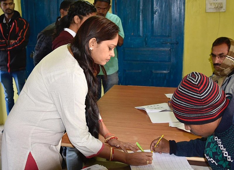 File:A lady signing a register, at a polling booth before casting her franchise, at Narayanpur, during the 1st phase of Chhattisgarh Assembly Election, on November 12, 2018.JPG