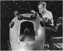 P-38 armament, concentrated in the nose of the aircraft An armorer's assistant in a large western aircraft plant works on the installation of one of the machine guns in the... - NARA - 196367.jpg