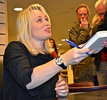 Heberlein signing a book at a bookstore in Stockholm in November 2011