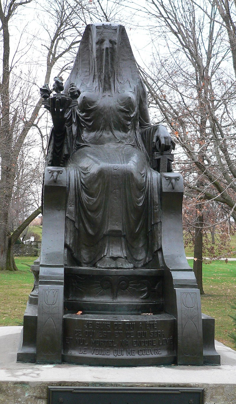 Statue of a woman on a throne covered by a veil
