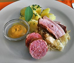 A dish containing most elements of the traditional Berner Platte: sauerkraut, potatoes, sausage, lardon and mustard Berner Platte, 2010.jpg