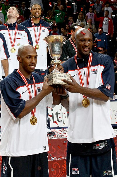 Billups (left) and Lamar Odom holding the 2010 FIBA World Championship trophy