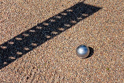 Boule and shadow of scoreboard in the boulodrome at Brastad arena