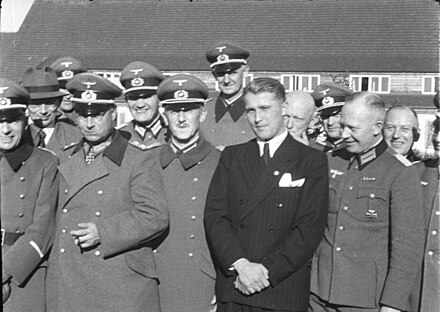 First rank, from left to right, General Walter Dornberger (partially hidden), General Friedrich Olbricht (with Knight's Cross), Major Heinz Brandt, and Wernher von Braun (in civilian dress) at Peenemünde, Province of Pomerania, in March 1941