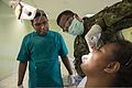 Canadian Army Capt. Withny Dagrain, center, examines a patient as Dr. Leslie Bunabo, left, a dentist, looks on during Pacific Partnership 2013 in Gizo, Solomon Islands, Aug. 2, 2013 130802-N-SP369-229.jpg