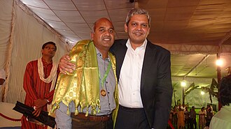 Dr Ravindra congratulated by Dr Ranga Reddy Burri at Tirupati World Telugu Conference.jpg