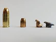 A 9mm hollow point cartridge, along with unexpanded and expanded bullets. The expanded lead bullet and copper jacket are separated Federal 9mm hollow point.jpg