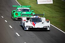 Tincknell leading Sebastian Priaulx at Road America during the 2023 IMSA SportsCar Weekend. Following (53108324605).jpg