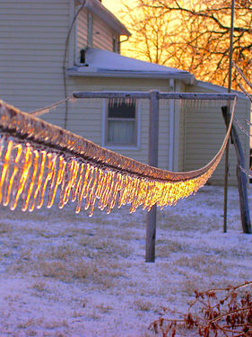 Sunset reflected in ice on a clothes line.