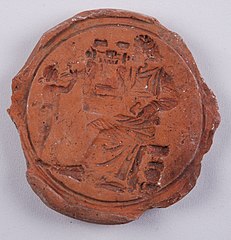 Калуп за израду медаљона и одливак у позитиву од керамике из 2—3. века. Потиче са локалитета Пазариштe у Малој Копашници