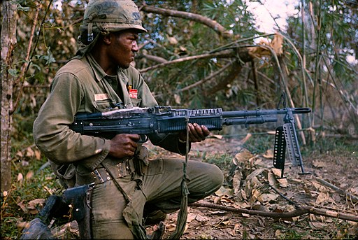 NARA 111-CCV-345-CC37981 25th Infantry Division soldier spraying tree line with M60 fire Operation Cedar Falls 1967