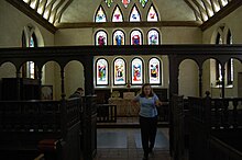 Interior with reproduction rood screen. Newport Parish Chancel.jpg