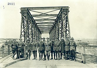Officers of the New Zealand Tunnelling Company pose at the completed Hermies-Havroncourt bridge over the Canal du Nord, October 1918. Officers of the New Zealand Engineers Tunnelling Company (14586452390).jpg