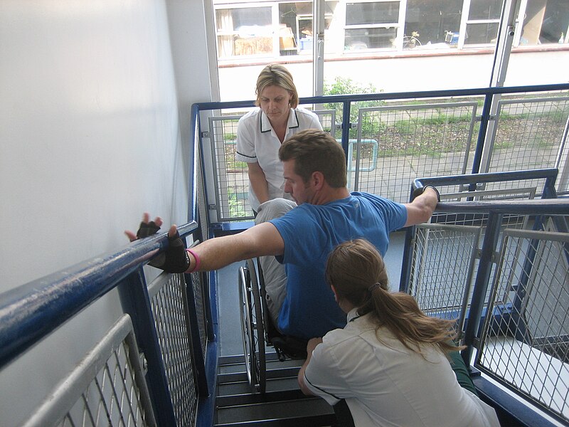 File:Phil learning how to climb stairs at RNOH Stanmore.JPG