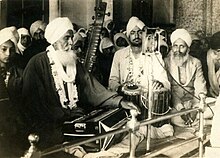 Photograph of Bhai Jawala Singh Ragi playing accordion (vaaja), Bhai Gurcharn Singh on Jori, and Bhai Avtar Singh on Taus at Gurdwara Dehra Sahib, Lahore, ca.1935 Photograph of Bhai Jawala Singh Ragi playing accordion (vaaja), Bhai Gurcharn Singh on Jori, and Bhai Avtar Singh on Taus at Gurdwara Dehra Sahib, Lahore, ca.1935.jpg