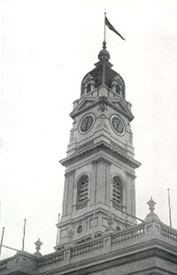 The VFA premiership flag flies above Prahran Town Hall in celebration of the Prahran Football Club's Grand Final victory, 1951