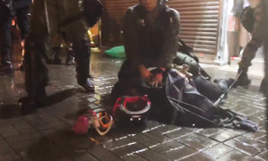 At 10 PM, in heavy rain, riot police dispersed protesters on Yen Chow Street.