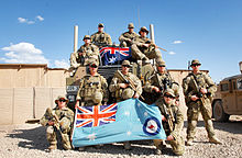 Royal Australian Air Force security force members pose with the RAAF ensign in Afghanistan.jpg