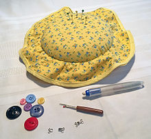 Some sewing notions: a pin cushion, pins, buttons, hooks and eyes, seam ripper, and sewing chalk Sewing Notions.jpg