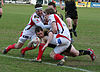 Shane Williams, with rugby ball, being tackled while scoring a try