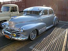 Lowrider began in the Mexican-American barrios of Los Angeles in the mid-to-late 1940s and during the post-war prosperity of the 1950s. Initially, some youths would place sandbags in the trunk of their customized cars in order to create a lowered effect. Solo s 48 Fleetline.jpg