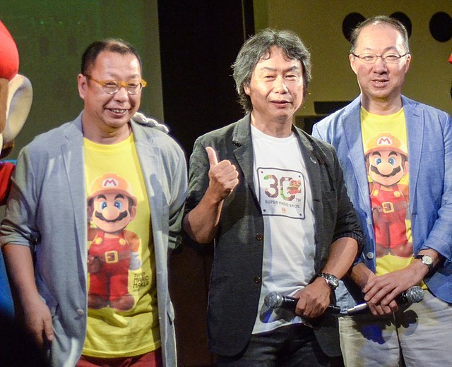Super Mario Bros. designer Takashi Tezuka, director Shigeru Miyamoto, and composer Koji Kondo, pictured in 2015