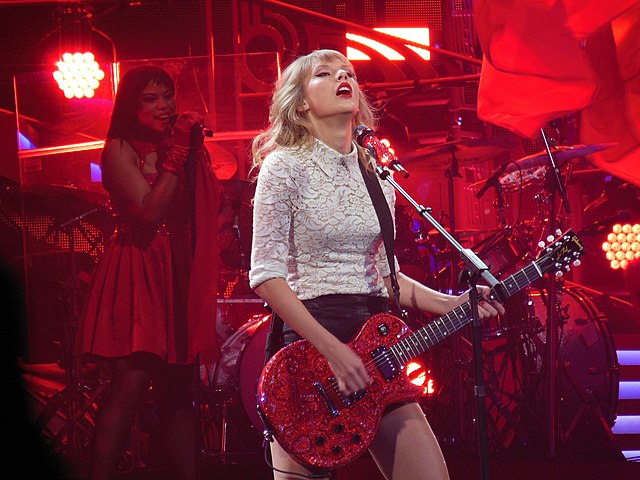 Swift performing "Red" on the Red Tour in 2013. Footage of the tour was included in the song's music video