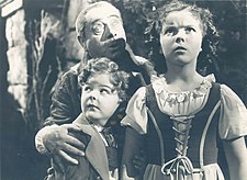 Johnny Russell (foreground), Eddie Collins, and Shirley Temple in a publicity photo for the film The Blue Bird press photograph, front (cropped).jpg