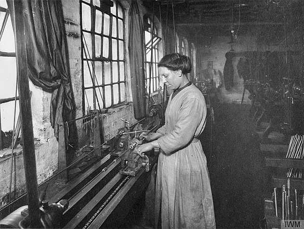 A female worker boring out the barrel of a Lee-Enfield rifle during WWI