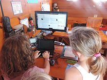 Reading Wikipedia through Kiwix on a boat in the South Pacific The Goodall girls using Kiwix aboard the Kyrimba.JPG