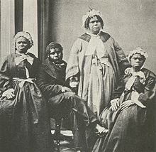 Four elderly full-blood Tasmanian Aboriginal people, c. 1860s. Truganini, for many years claimed to be the last full-blood Aboriginal person to survive, is seated far right. Truganini and last 4 tasmanian aborigines.jpg