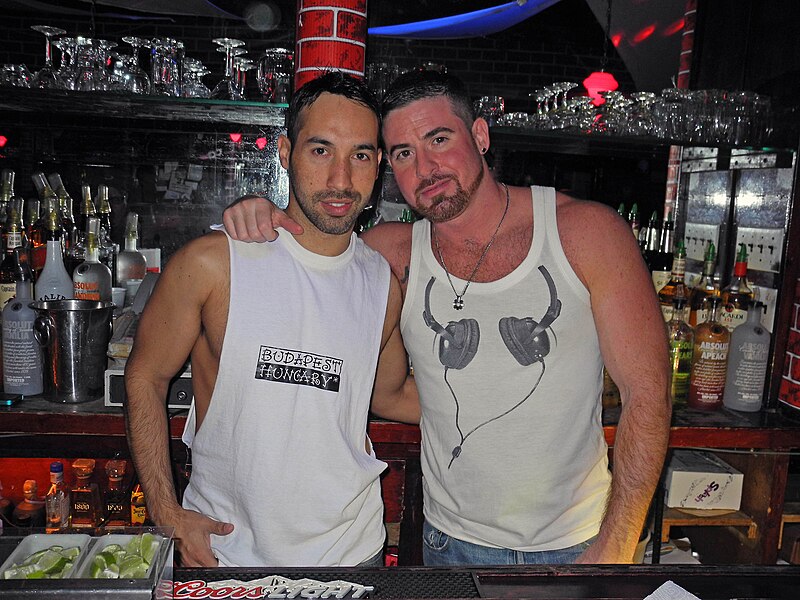 File:Two men in tank tops at The Music Box in Queens.jpg