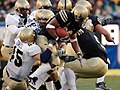 US Navy 051203-N-9693M-505 Army fullback Mike Viti (33) is tackled by a trio of Navy defenders during the 106th Army vs. Navy Football game, held for the third consecutive year at Lincoln Financial Field.jpg