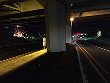 The beginning/end of SR 659 under I-580/US 395, noted by the mileposts indicating 0.00 on one side and 22.98 on the other 2015-11-03 04 55 07 Mileposts at the beginning and end of Nevada State Route 659 (McCarran Boulevard) under Interstate 580 and U.S. Route 395 in Reno, Nevada.jpg