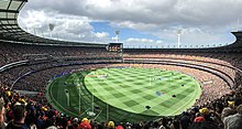 The Melbourne Cricket Ground is strongly associated with the history and development of cricket and Australian rules football, Australia's two most popular spectator sports. 2017 AFL Grand Final panorama during national anthem.jpg