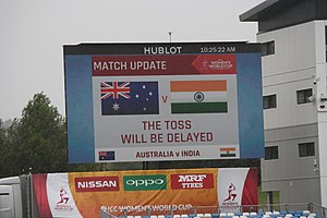 Scoreboard stating the toss is delayed. 2017 Women's Cricket World Cup (35334447733).jpg