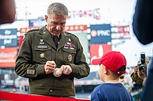 US Army Chief of Staff General James C. McConville wearing an Eisenhower jacket at a public event in 2022. Army chief of staff General James C. McConville signs baseball, June 16, 2022.jpg